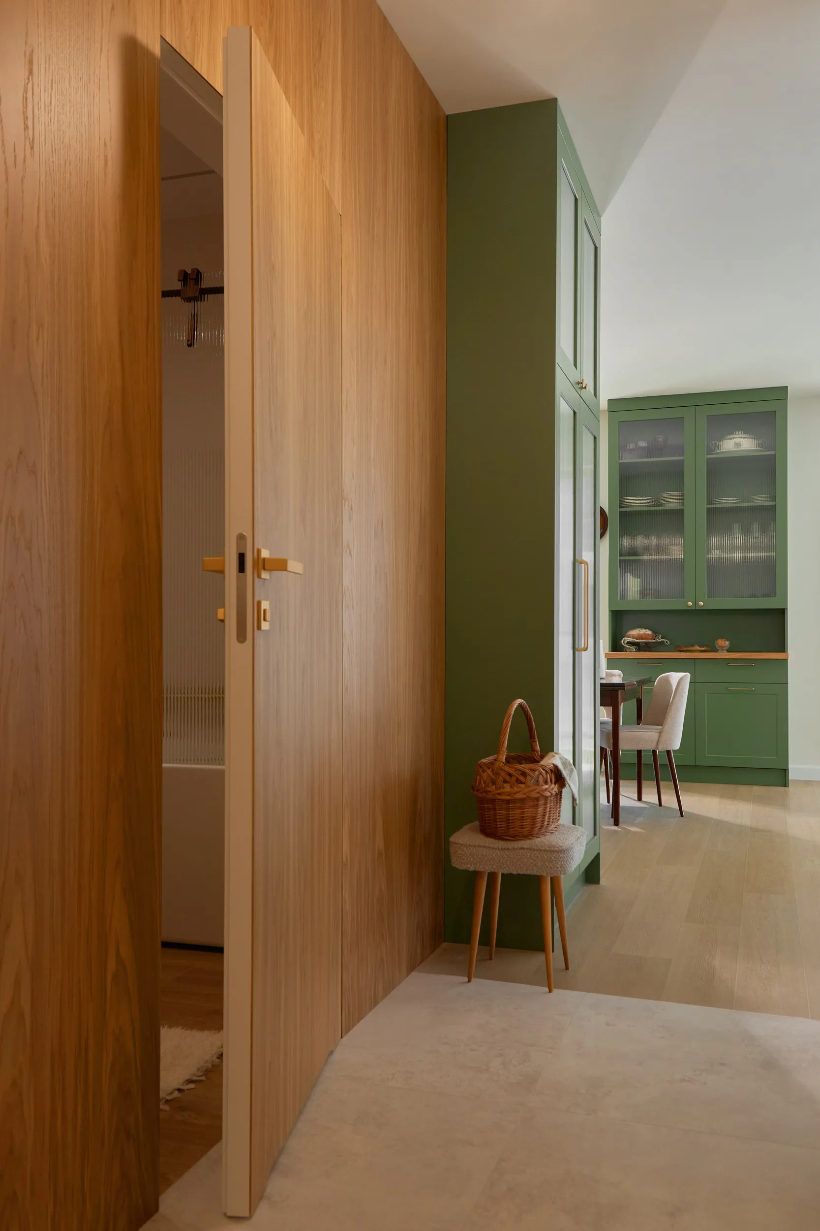 Modern custom kitchen installed in a Bellevue home — sage cabinetry with reeded glass